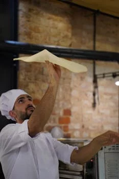 pizza chef tossing dough skillfully
